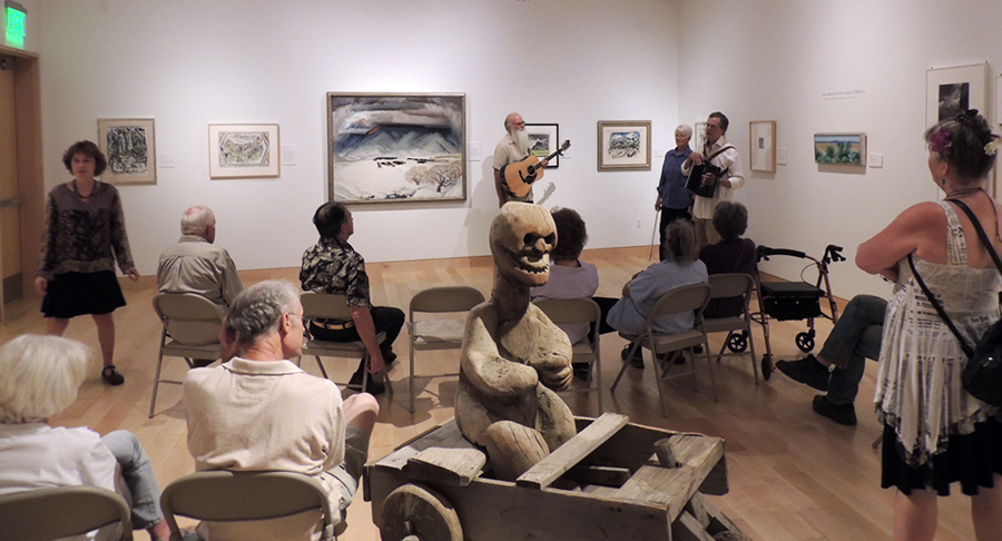 An Artstreams group gathers in the gallery to look at art and listen to music inspired by the paintings.