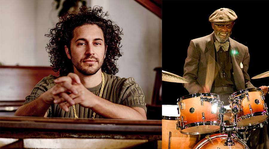 Side-by-side images of Emmet Cohen, a light skinned man with long curly hair, sitting at a piano with his hands resting on top and Tootie Heath, a dark-skinned man sitting at a drum set wearing a matching cap and coat.