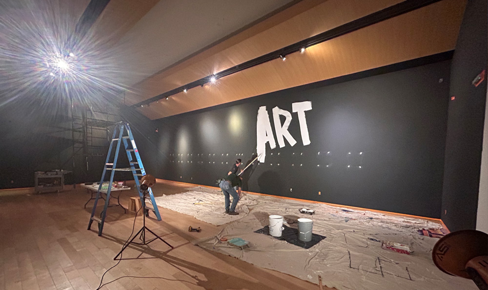 a large wall is painted with the word "Art" in large letters