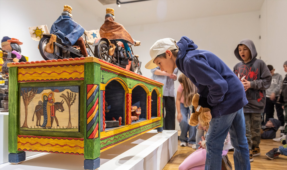 children on a school tour viewing artwork in the gallery