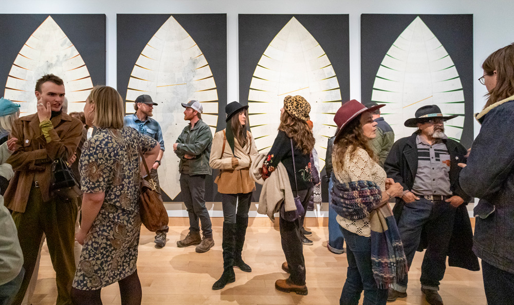 group of patrons viewing large artwork in the gallery